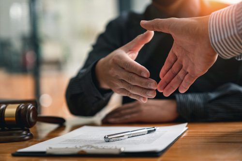 Lawyers shake hands with business people to seal a deal with par