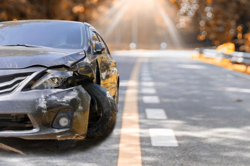 Artumn road. Front of black color car big damaged and broken by